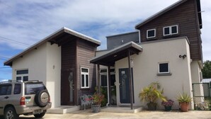 A two-story house with a front porch, a garage, and a driveway. - Hill Rise Retreat One (Harrow Park)