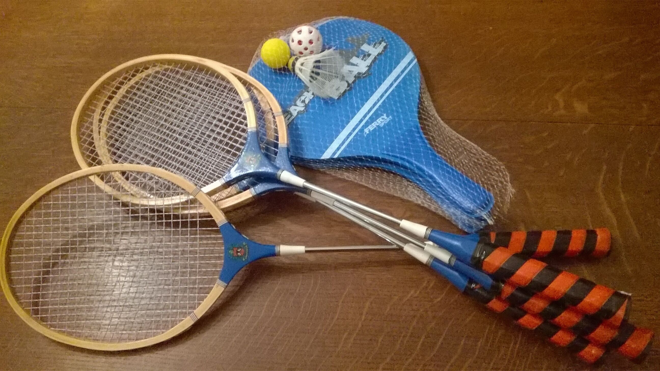 A badminton racket, a shuttlecock, and a blue sports bag with a net.