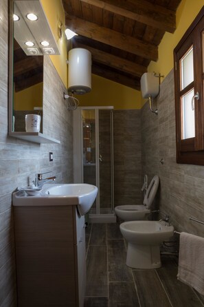 Deluxe Triple Room, Partial Sea View | Bathroom | Shower, free toiletries, hair dryer, towels - Arroccas de Is Istellas (Arbus)
