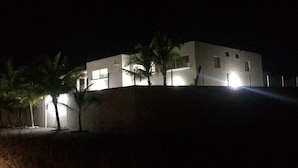 A modern building with a flat roof, surrounded by palm trees. - La Casa de la Playa (Cuyutlan)