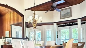 A spacious dining area with a high ceiling, wooden beams, and a chandelier. - 1800's Church, Restored And Converted To A Designers Private Beach Retreat (Coloma)