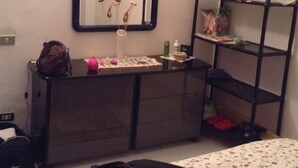 A bedroom with a dresser, a mirror, a shelf unit, and a bed. - MOUNTAIN HOUSE PESCASSEROLI (pescasseroli)