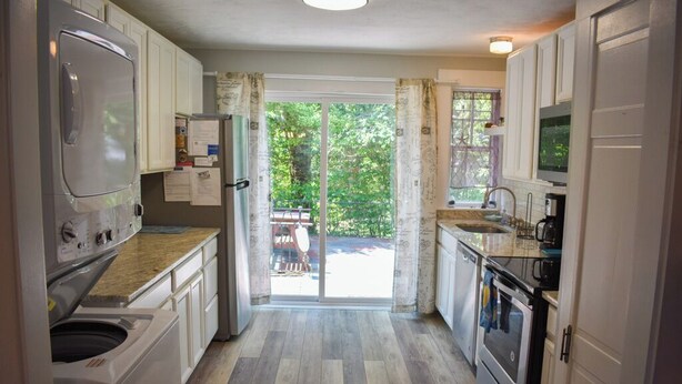 A kitchen with a washing machine, a refrigerator, a microwave, and a stove. - Dennis Port beach home less than two tenths of a mile to Haigis public beach (Dennis Port)