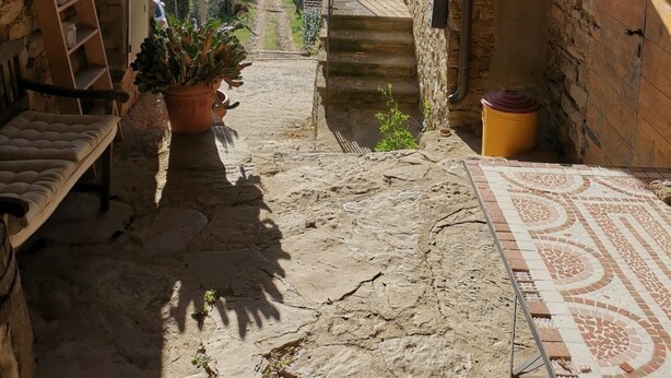 A rustic stone archway leading to a balcony with a view of distant hills. - Typical Tuscan Residence near the farm la Vialla (Ponina)