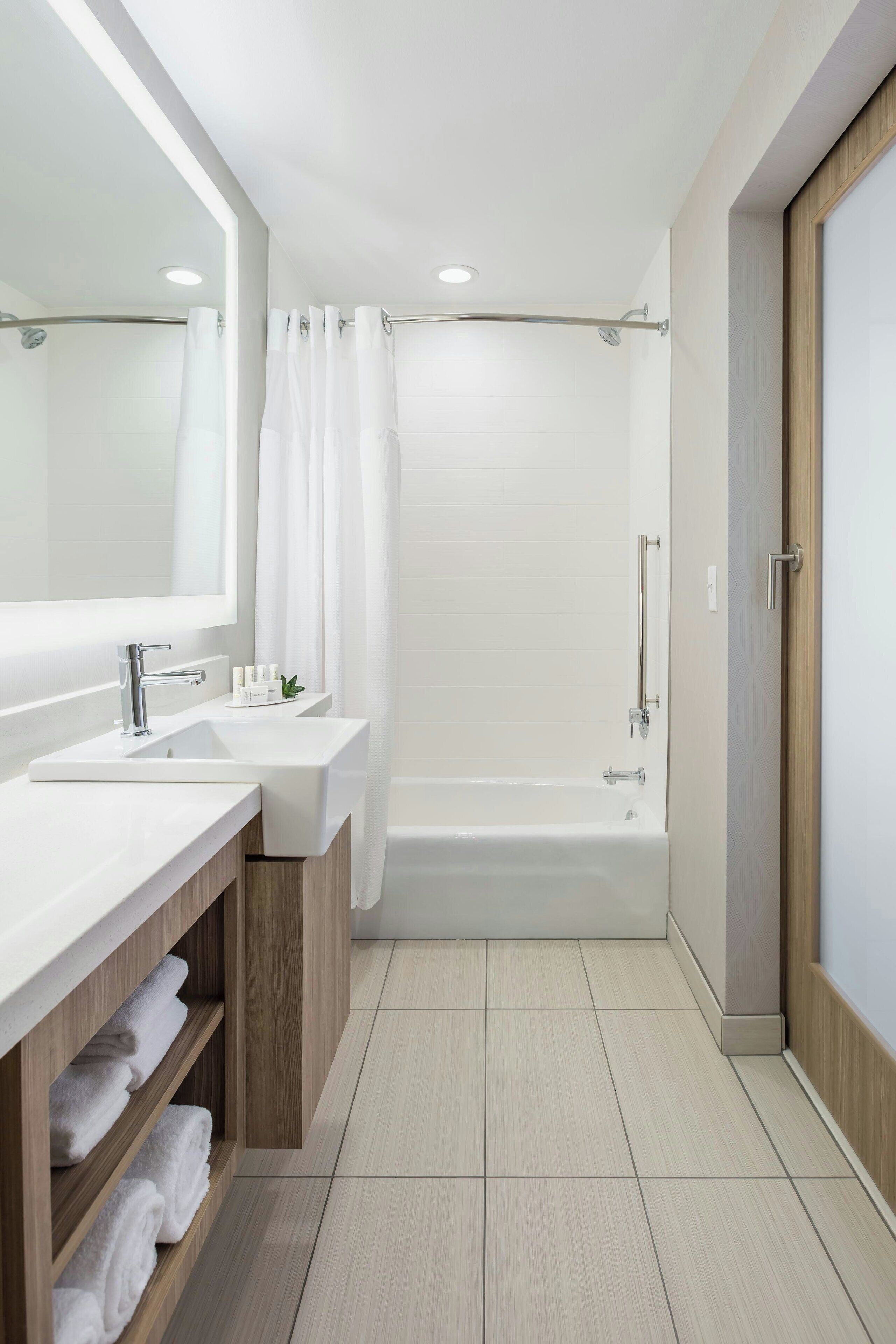 shower, designer toiletries, hair dryer, towels