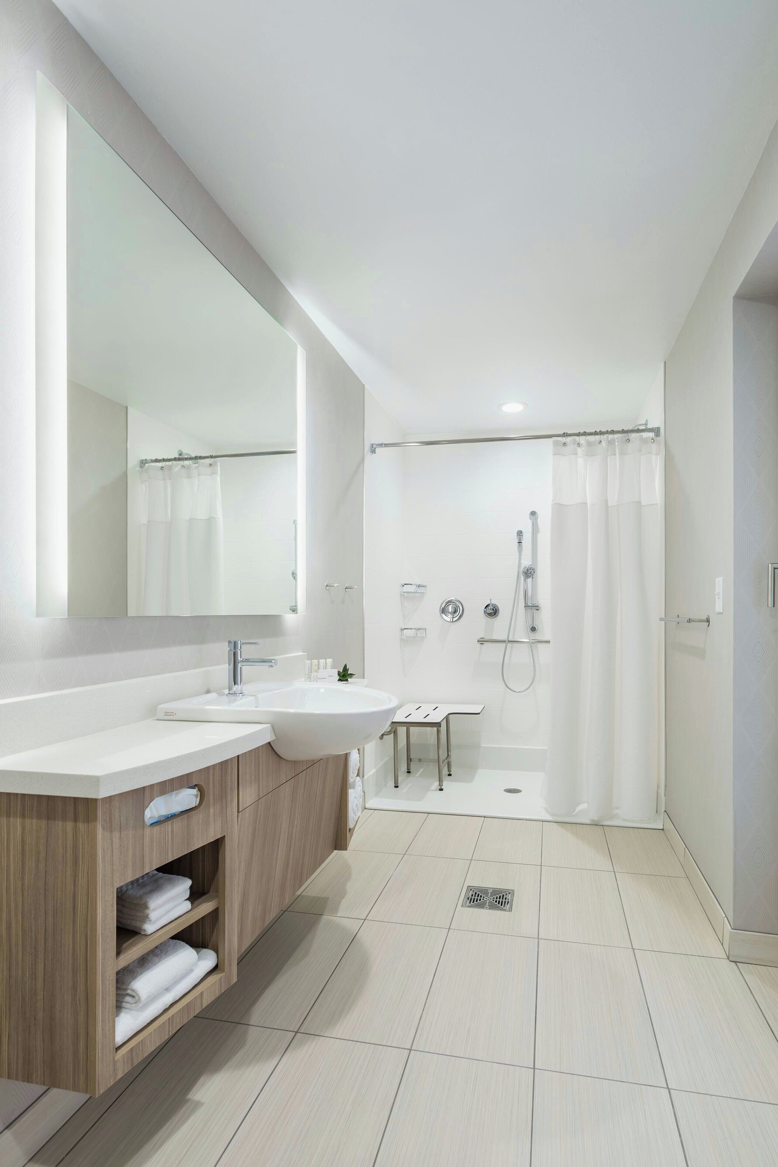 shower, designer toiletries, hair dryer, towels