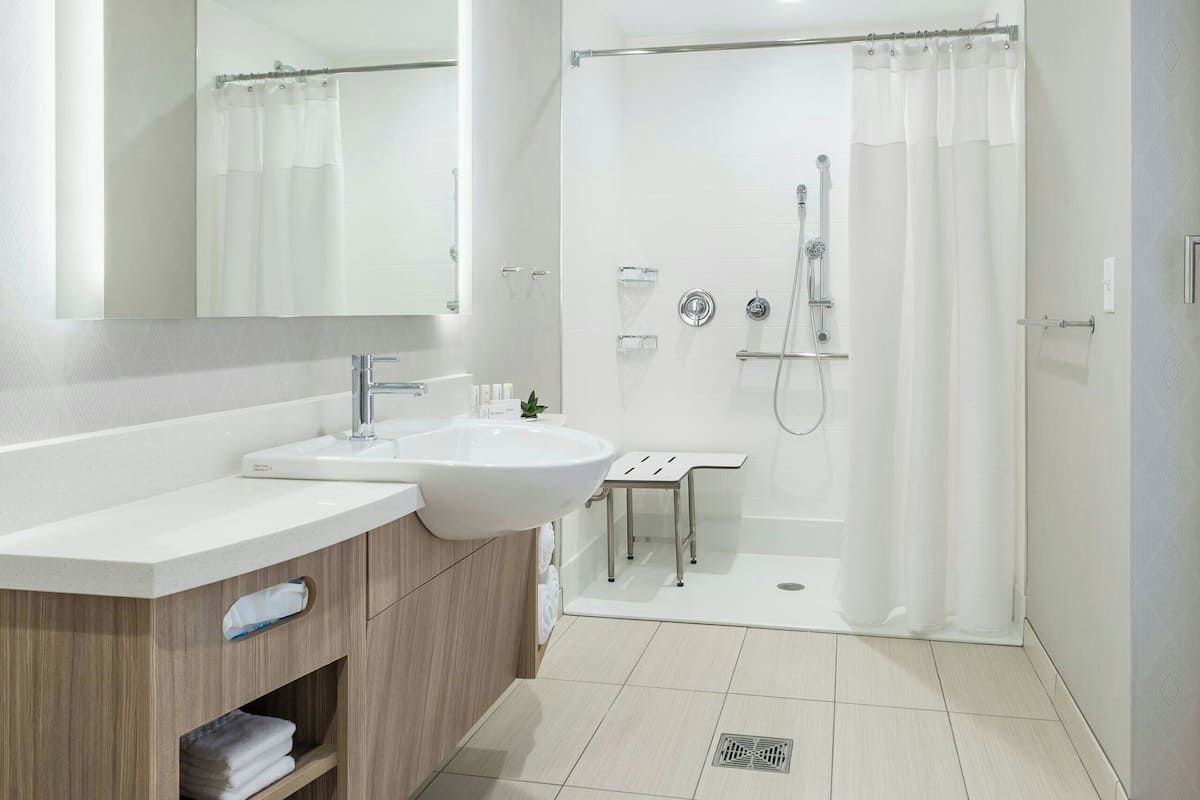 shower, designer toiletries, hair dryer, towels