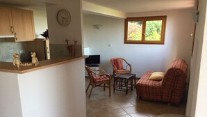 A compact living space with a kitchen area, a dining table, and a seating area with two chairs and a sofa. - T4 plus T2 independent. (Pietrosella)