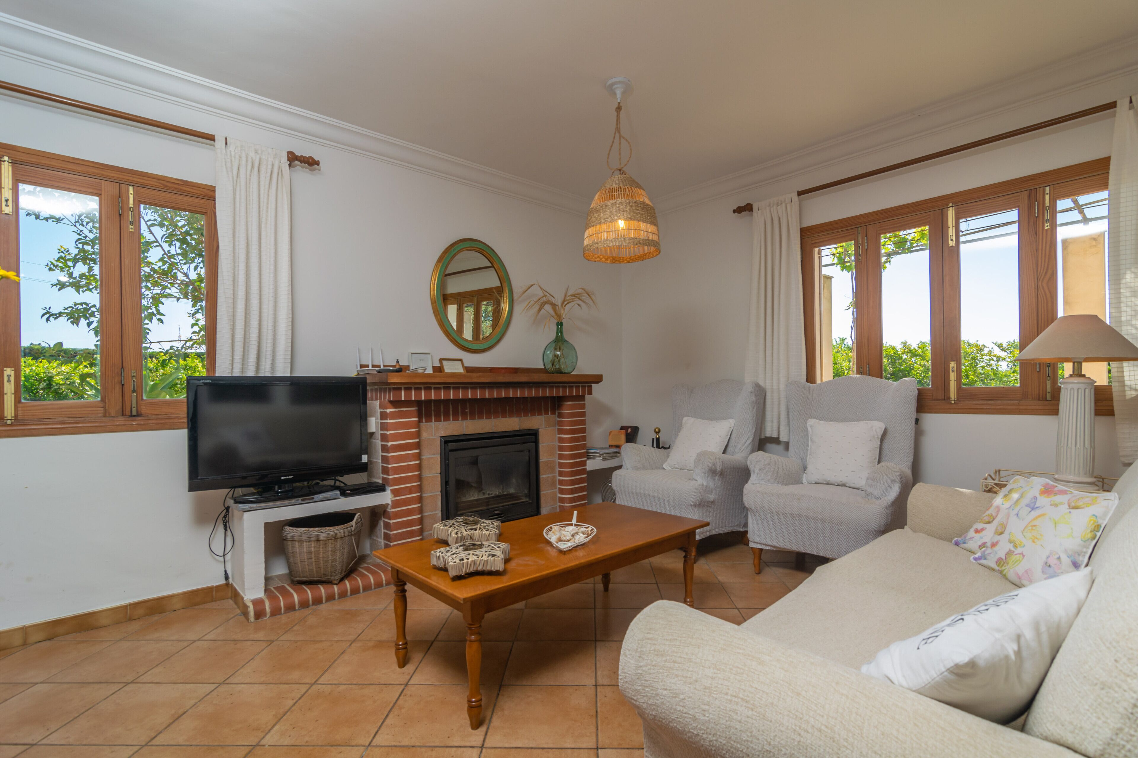 A living room with a fireplace, television, and seating area.