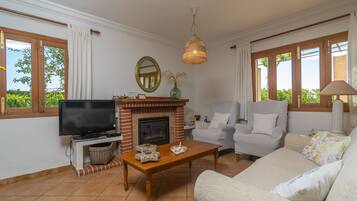 A living room with a fireplace, television, and seating area.