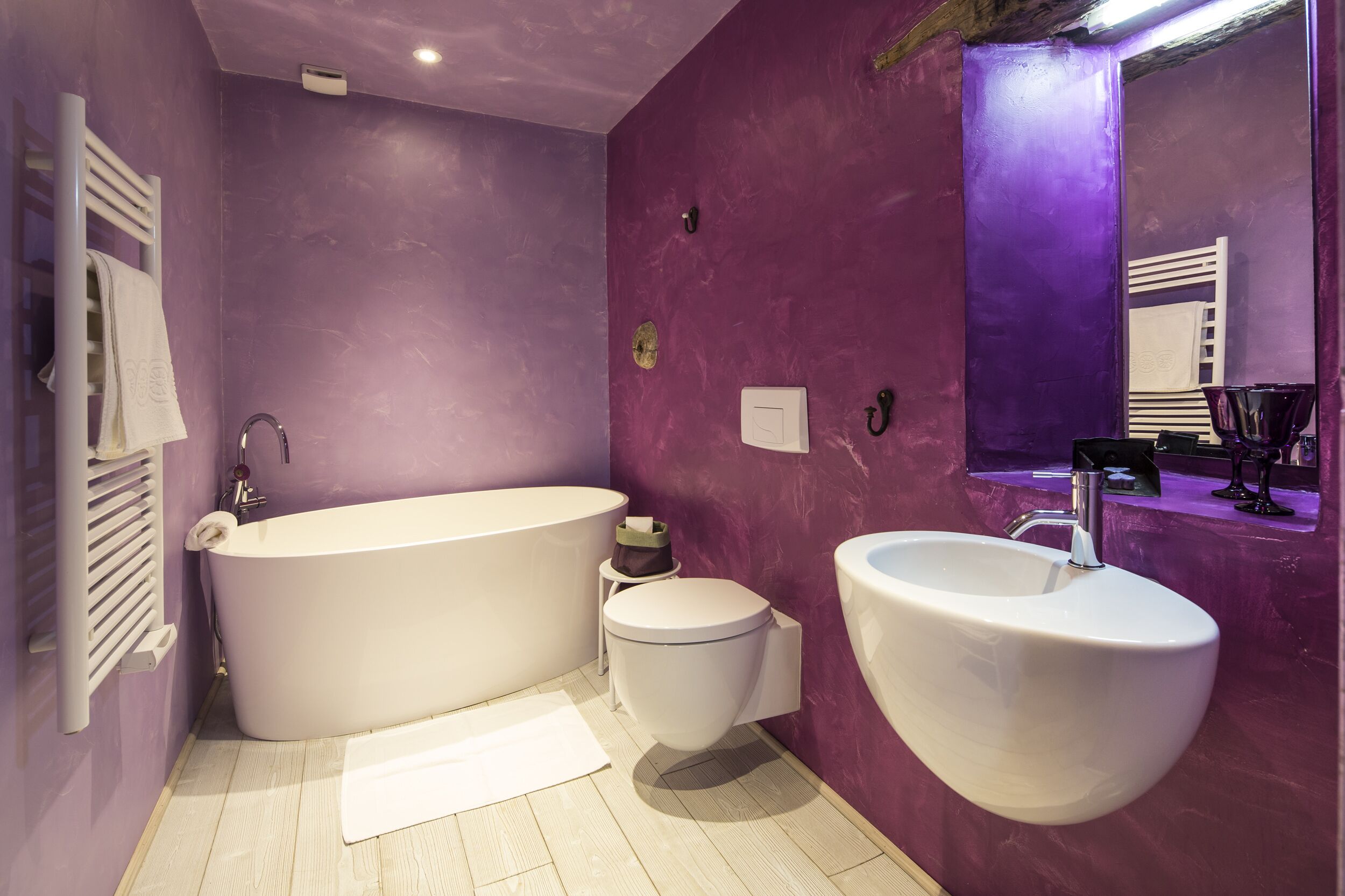 A bathroom with a bathtub, toilet, and sink.