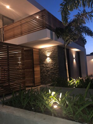 Stylish building with a sleek, minimalist design, featuring a well-maintained garden.