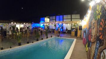 Outdoor pool, open 9:00 AM to 9:00 PM, pool umbrellas, pool loungers