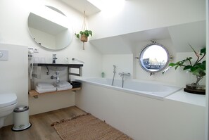Bathtub, hair dryer, towels, soap