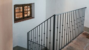 A staircase with a wooden beam ceiling, a small window, and a metal railing. - Villa Cenami on hilltop - Alba apartment - big POOL with view near by seaside (Massarosa)