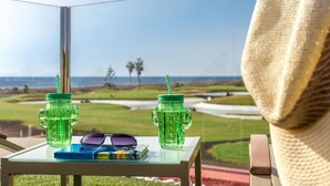 A table with a green mason jar, a pair of sunglasses, and a book. - Unique Family Villa! Spa, Ocean view, Heated Pool, Rooftop (Antigua)