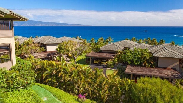 A resort with multiple buildings, a clear view of the ocean, and lush greenery. - Kapalua Ridge Villa 1124 Luxury Oceanview Retreat (Lahaina)