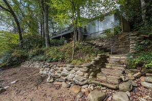 A stone staircase leading up to a house surrounded by trees. - Rivers Edge Cabin, Swimming, Tubing, Fishing, Fire Pit, Grill, Wi-Fi, Relaxing! (Burnsville)