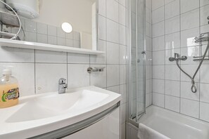 Bathtub, hair dryer, towels, soap