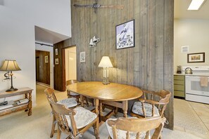 A dining area with a wooden table and chairs, a lamp, and a framed picture on the wall. - Rustic Ski Lodge - within minutes of Alta and Snowbird (Alta)