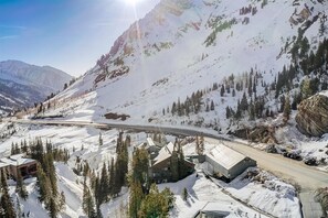 A snow-covered mountain road with buildings and trees along the side. - Rustic Ski Lodge - within minutes of Alta and Snowbird (Alta)