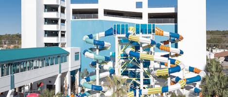 A water park with multiple slides and a building with balconies.