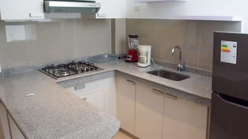 Family Apartment, Multiple Beds | Private kitchen | Coffee/tea maker, cookware/dishes/utensils