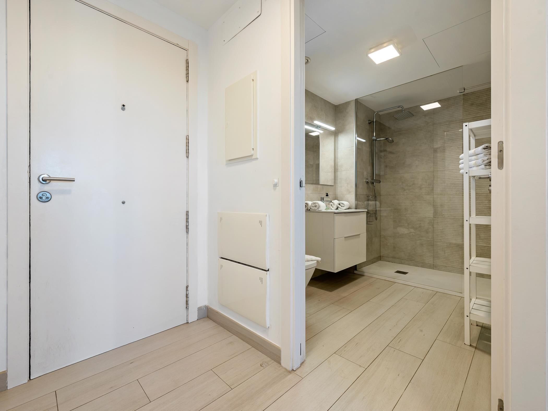 A modern bathroom with a toilet, sink, and shower area.
