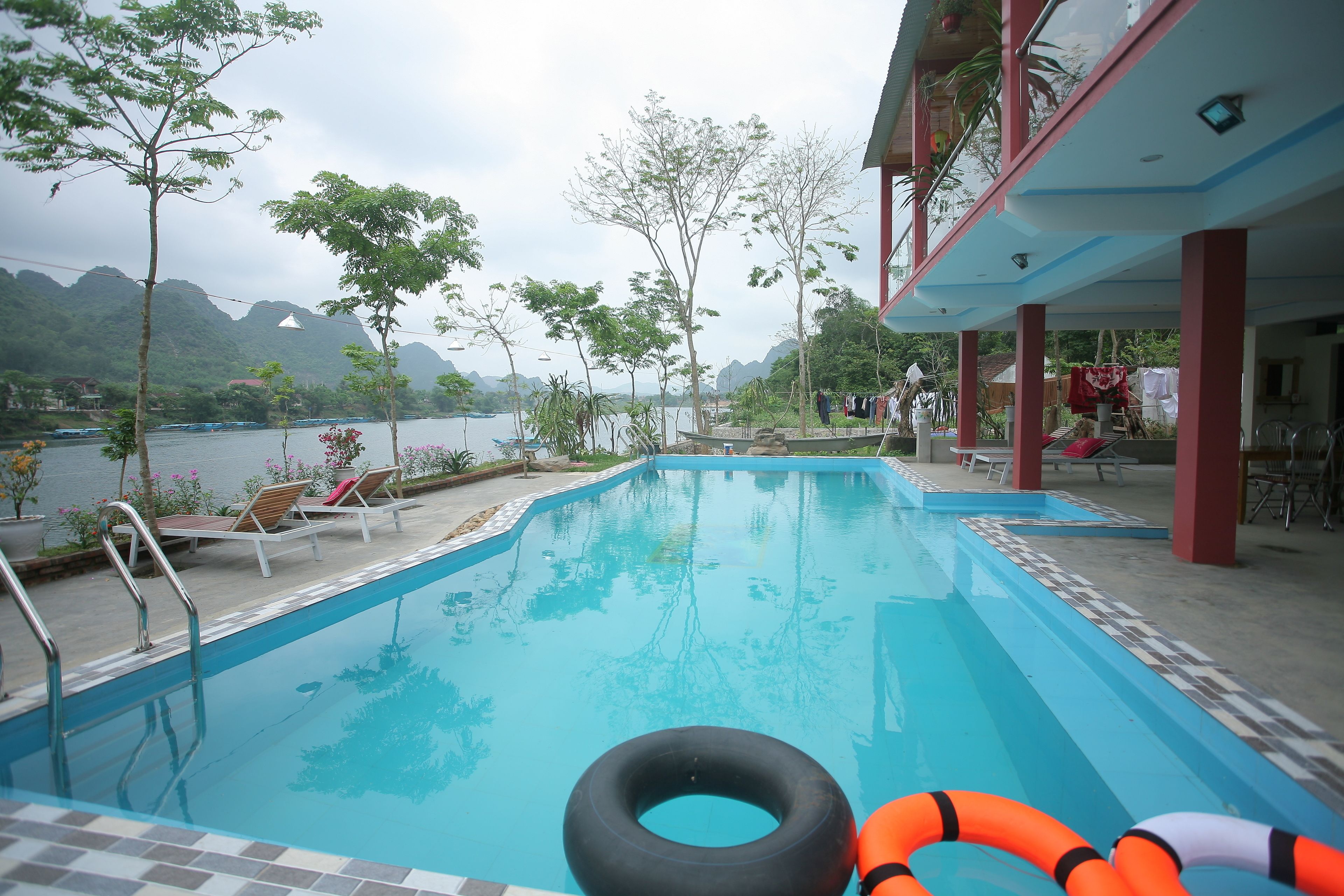 A swimming pool with lounge chairs and a view of the mountains.