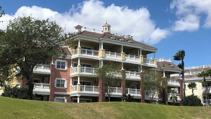 Un edificio a più piani con un cortile centrale, caratterizzato da balconi e una torre imponente.