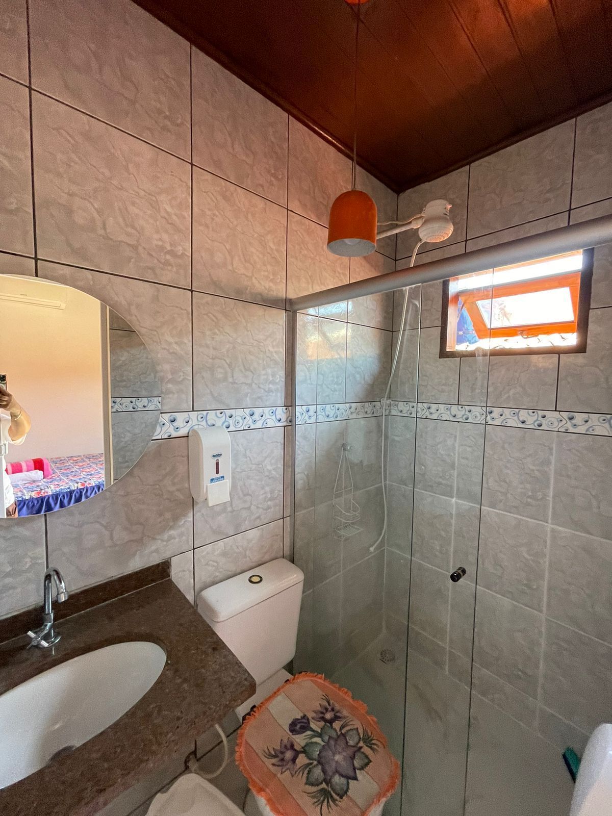 A bathroom with a sink, toilet, and shower.
