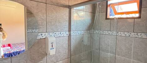 A bathroom with a sink, toilet, and shower.