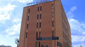 A tall brick building with the sign "KÖRKEM HOTEL" at the top.