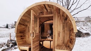A wooden sauna structure with two benches and a table inside. - Elroy's @ Big Rock Creek: Where Adventure Meets Comfort in the St. Croix Valley (Saint Croix Falls)