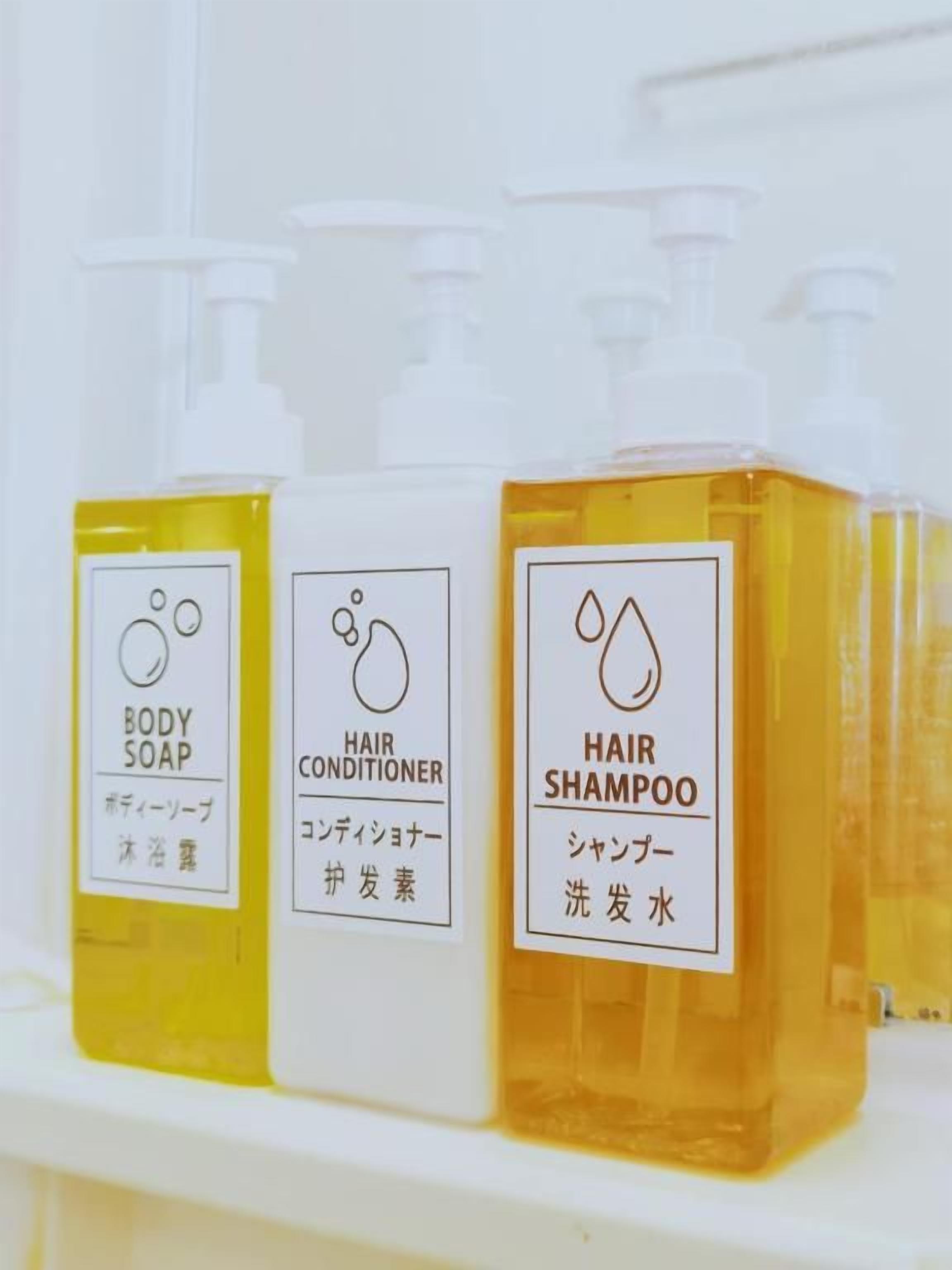 Three bottles of personal care products on a shelf.