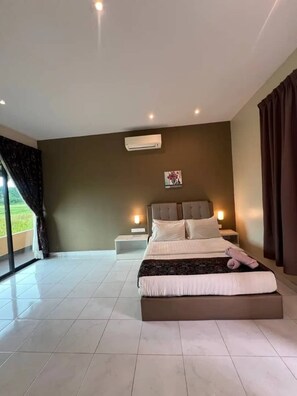 A bedroom with a large bed, bedside tables, an air conditioning unit, and a view through the window. - Nahdhoh Langkawi Resort (Langkawi)