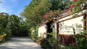 A pathway leading to a building with a sign reading "The Royal Inn".