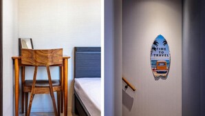 A bedroom with a wooden chair, a bed, and a wall with a 'TIME TO TRAVEL' sign. - The Gate Hostel Shonan Fujisawa (Fujisawa)