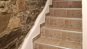A staircase with stone walls on one side and tiled steps. - Korala Apartments (Piran)