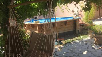 Seasonal outdoor pool, open noon to 8:00 PM, pool umbrellas