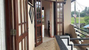 A corridor leading to a room with a view of a sports field. - Cinnamon City (Hikkaduwa)