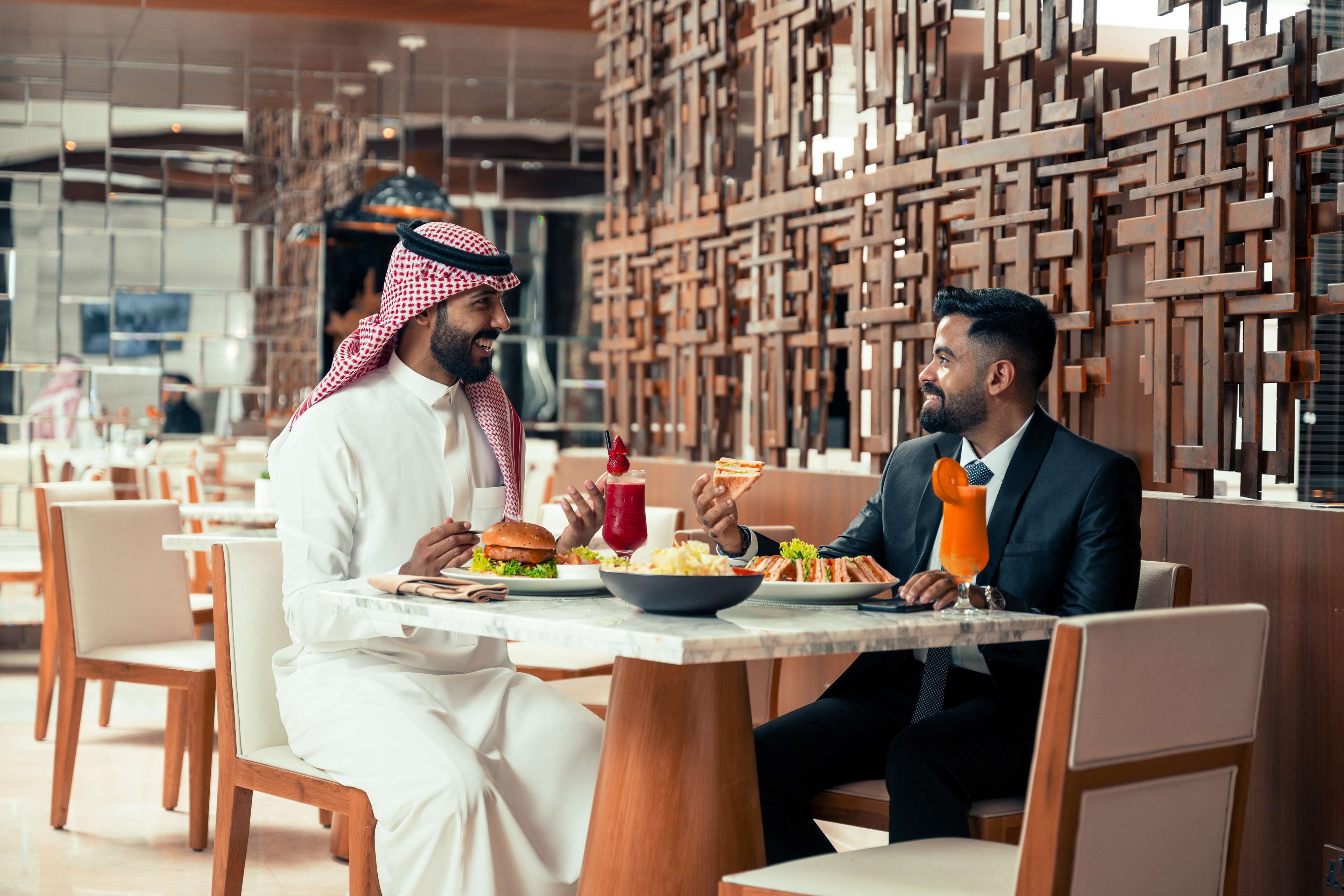 A restaurant with wooden decor and modern furniture.