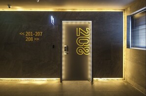 A modern elevator with a metallic finish and illuminated numbers '202' on the door. - Hotel Crape Gyeongsan (Gyeongsan)