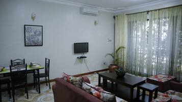 Apartment, 1 Bedroom | Living area | Flat-screen TV
