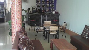 A reception area with a counter, seating, and a wall displaying various items.