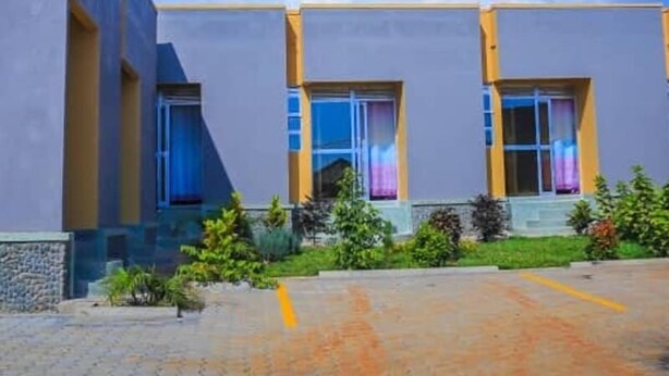 A modern building with a flat roof and large windows.