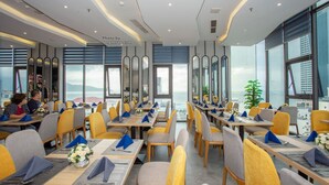 A modern restaurant with a view of the city skyline.