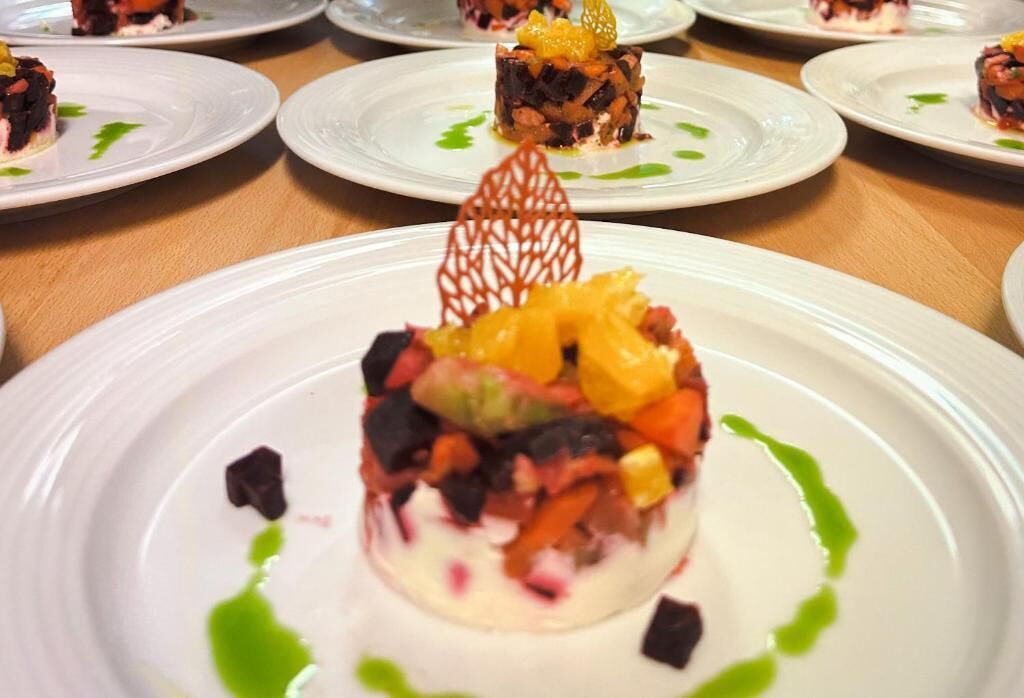 A dessert on a white plate with a decorative leaf garnish.