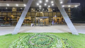 A modern building with a unique architectural design featuring large, angular concrete structures. - Shimall Hotel (Gaziantep)