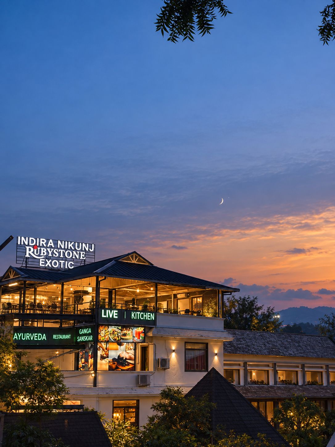 A multi-story building with a sign for 'Indira Nikunj Rubystone Exotic' and 'Live Kitchen' indicating a restaurant.